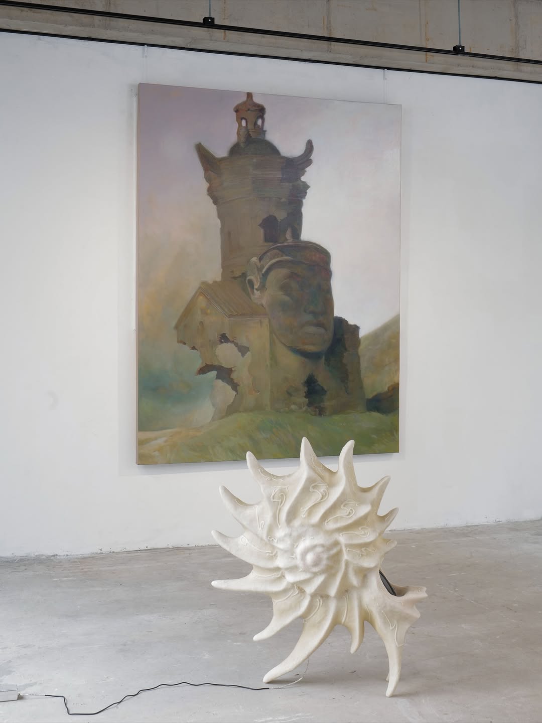 Installation view — Phanteon (large painting) on white wall with sun sculpture on concrete floor