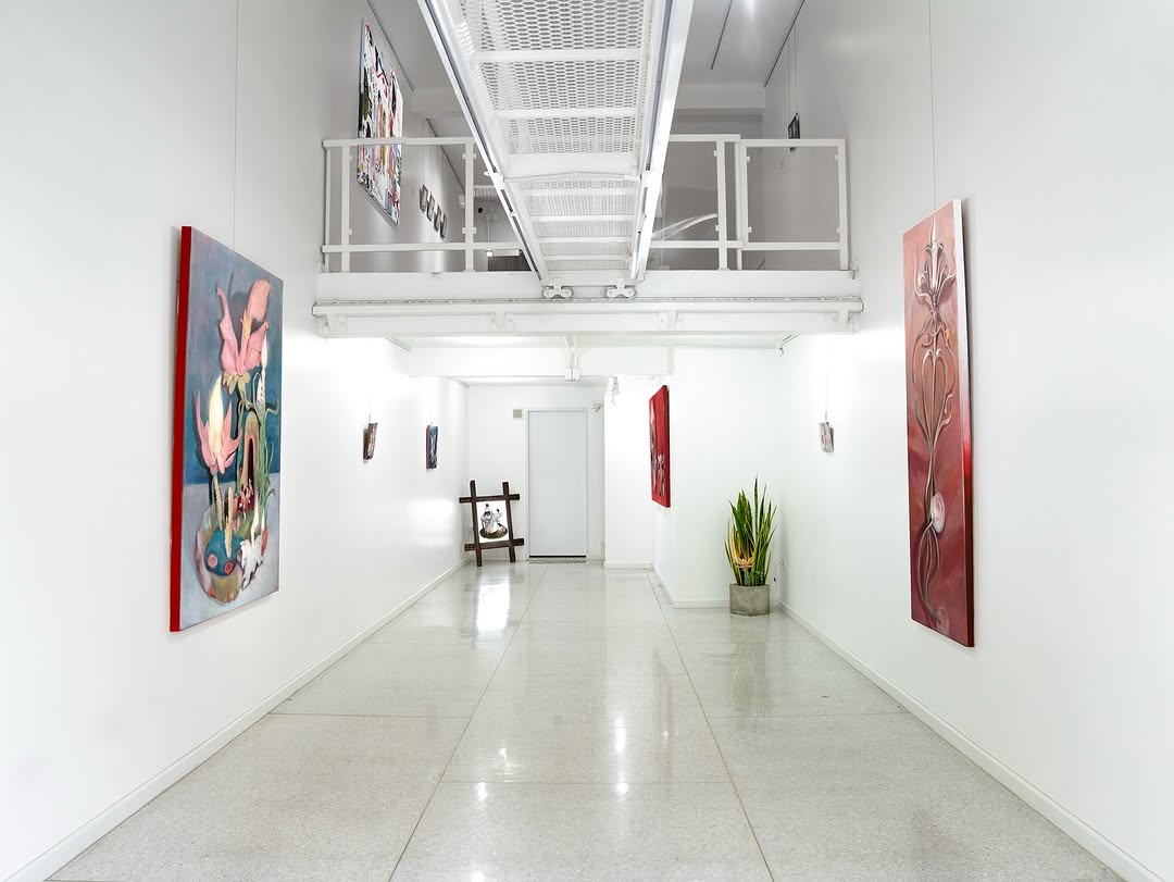 TENÚ — installation view, long gallery corridor with paintings on both walls